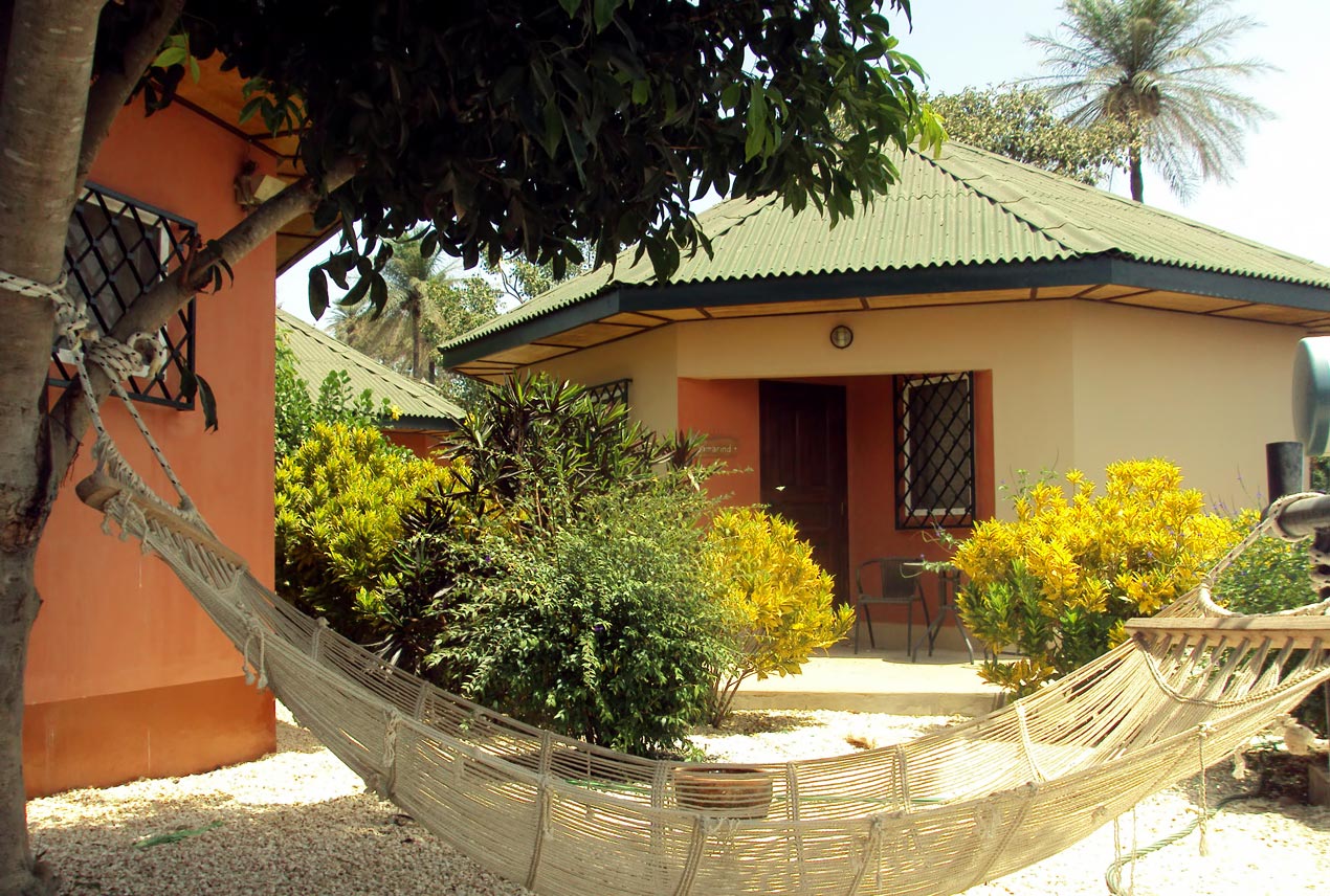 Relaxing hammock with a view of an eco-friendly lodge at Elsewhere@Farakunku